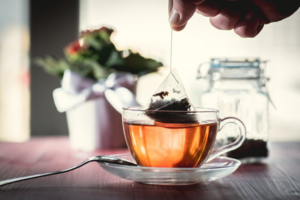 Close up of patient removing a tea bag from a teacup